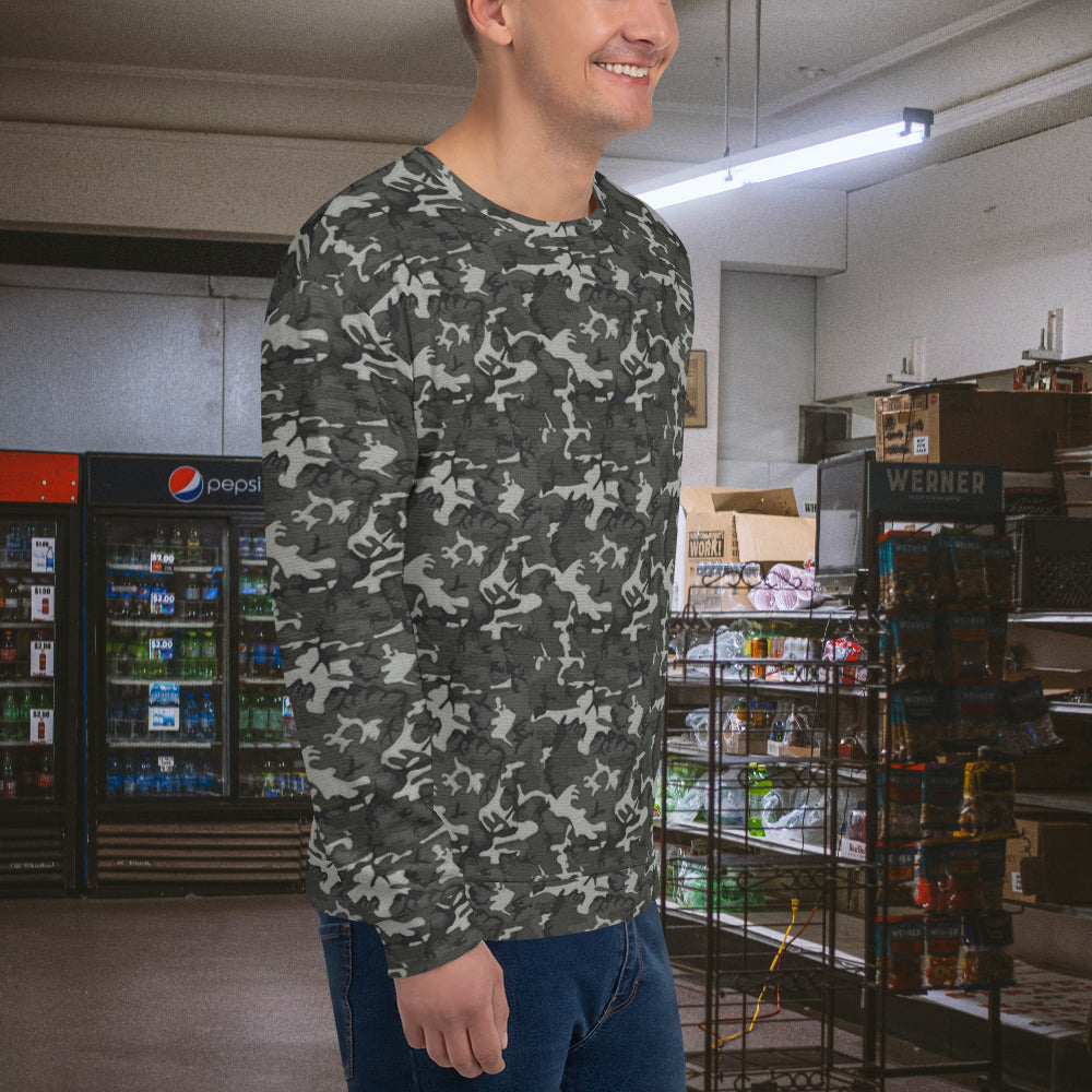 Man smiling in a store wearing an urban-style camo sweatshirt