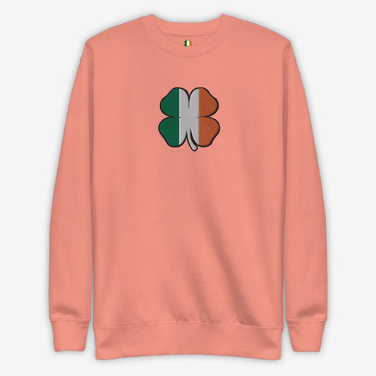 Flat lay of a dusty rose sweater with a shamrock design, perfect for St. Patrick's Day.