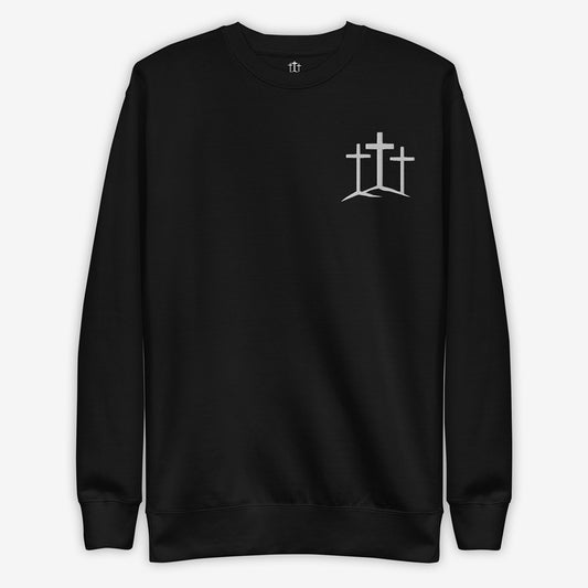 Black soft sweatshirt with minimalist cross embroidery displayed flat