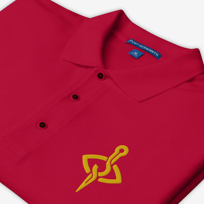 Folded View of a Stitch Art Embroidered Polo in silver with a distinctive needle and thread logo, showcasing a blend of style and craftsmanship. Color Red.