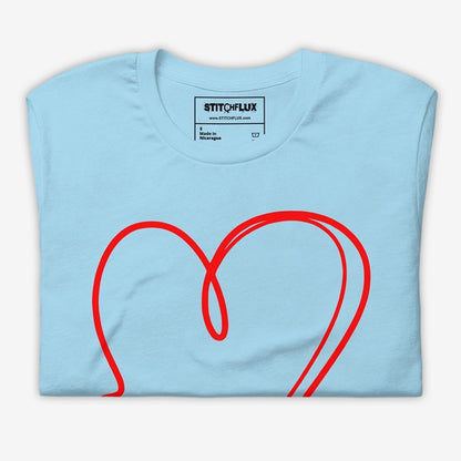 Neatly folded light blue unisex t-shirt with red heart design visible on top - product presentation.