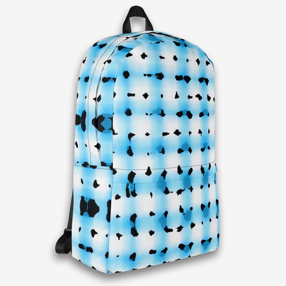 Right-side view of a contemporary backpack with a playful pattern of blue and black on white, showcasing the side pocket and zip closure.