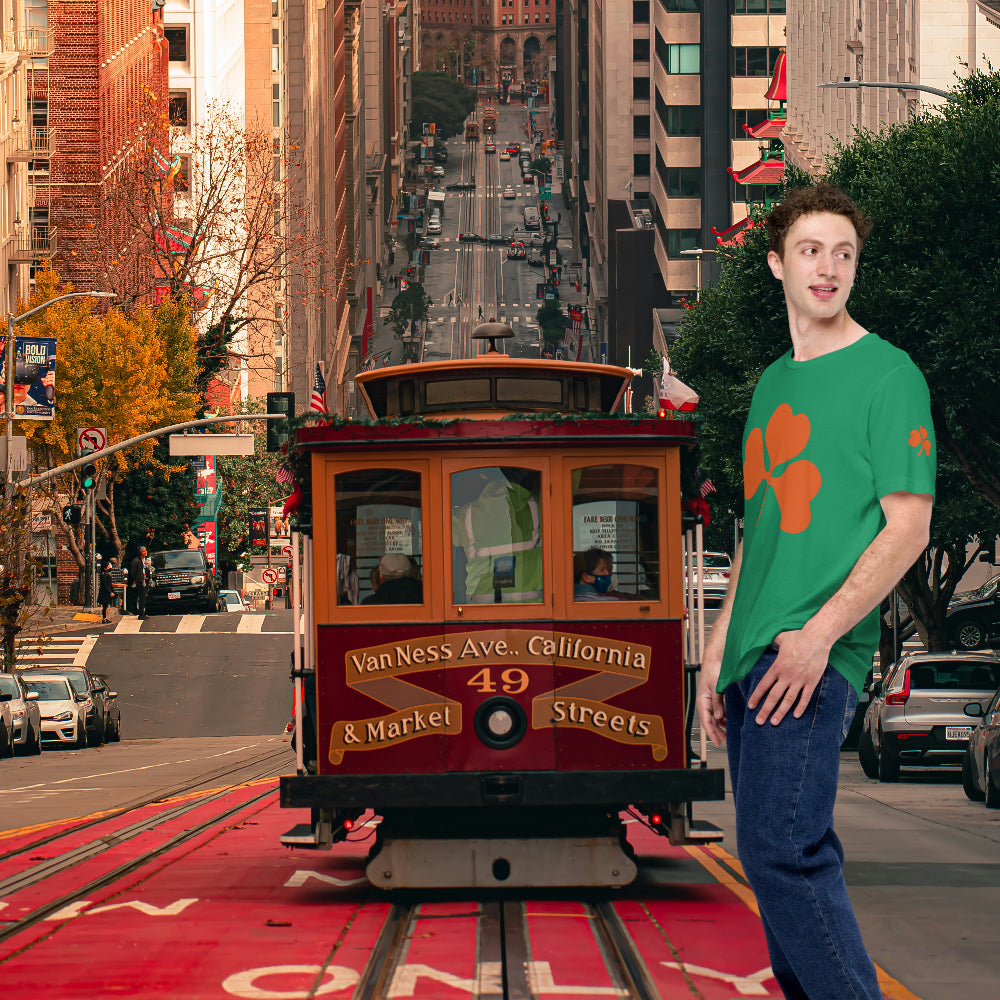 Man in a green clover T-shirt in front of a San Francisco cable car.