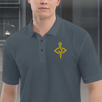 Model wearing a Stitch Art Embroidered Polo in silver with a distinctive needle and thread logo, showcasing a blend of style and craftsmanship. Close up on male model.