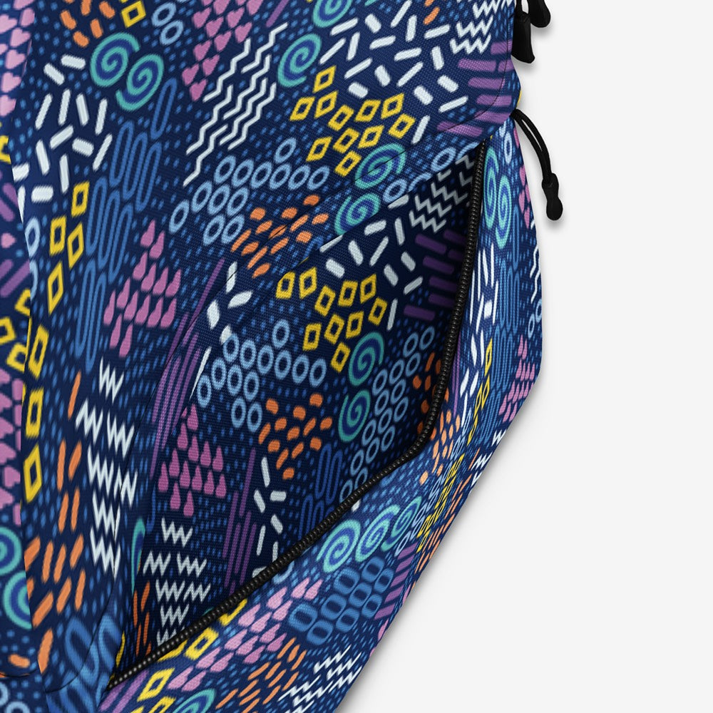 Close-up of the backpack’s fabric, highlighting the detailed geometric print and quality material.