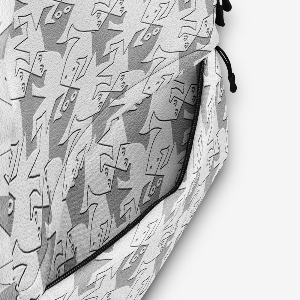 Close-up of the backpack's fabric showing the black-and-white geometric pattern detail.